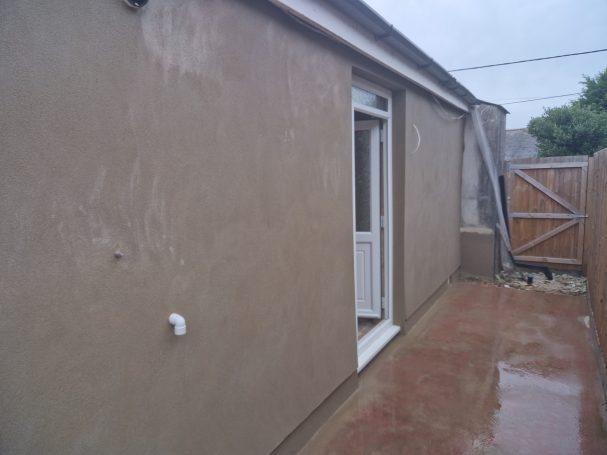 Bungalow side render freshly rendered wall